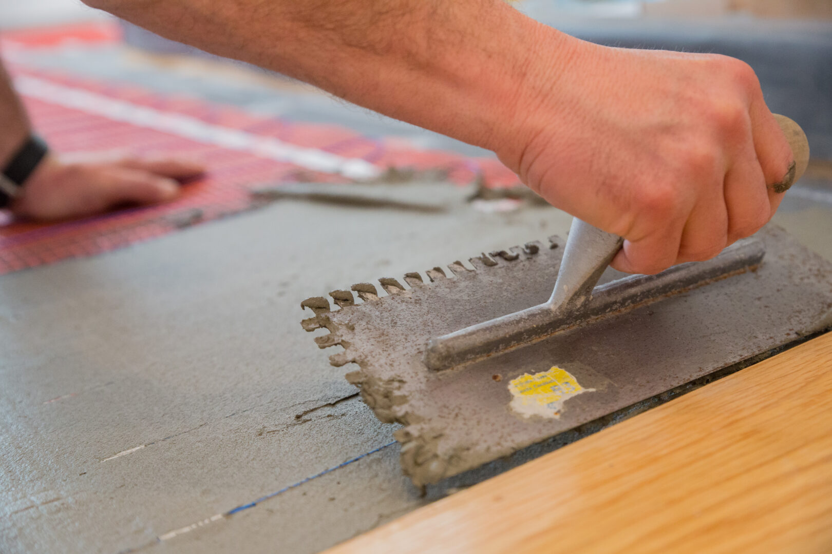 Radiant heated floor installation with modified vs. unmodified thinset